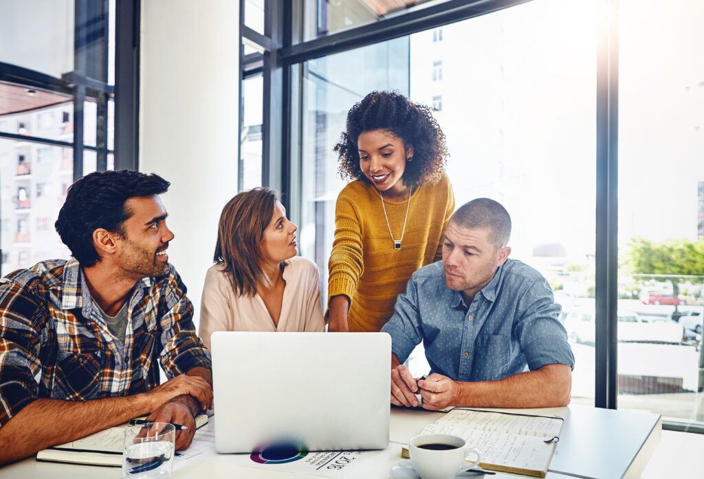 Four teammates discussing proactive processes for technology