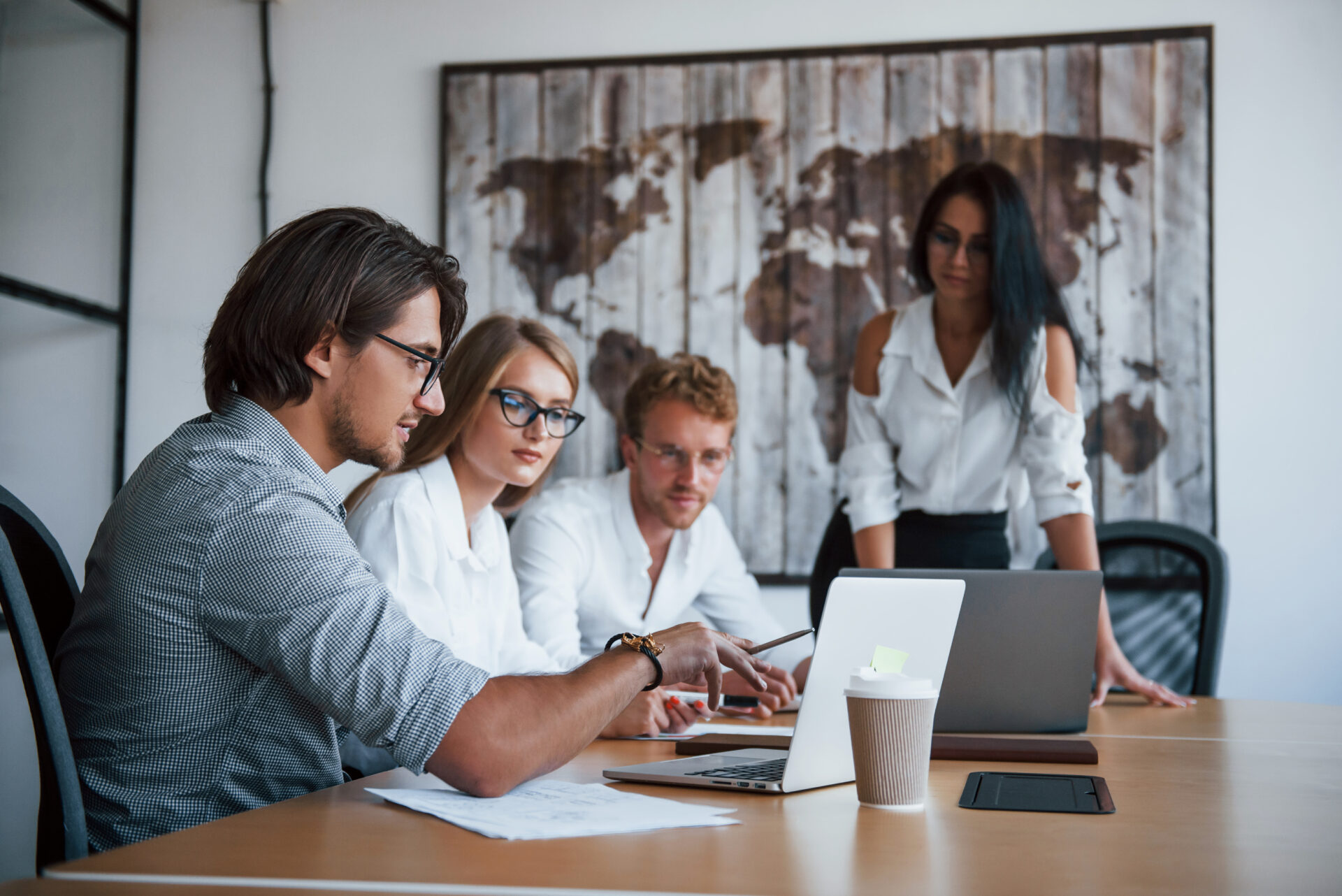 Group of people around a laptop working on AI