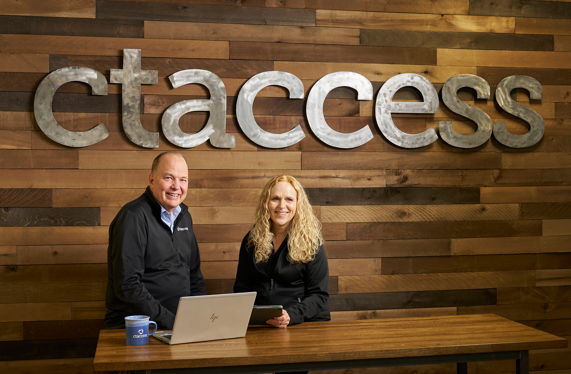 A photo of Vicki and Scott Hirschfeld in front of a ctaccess sign