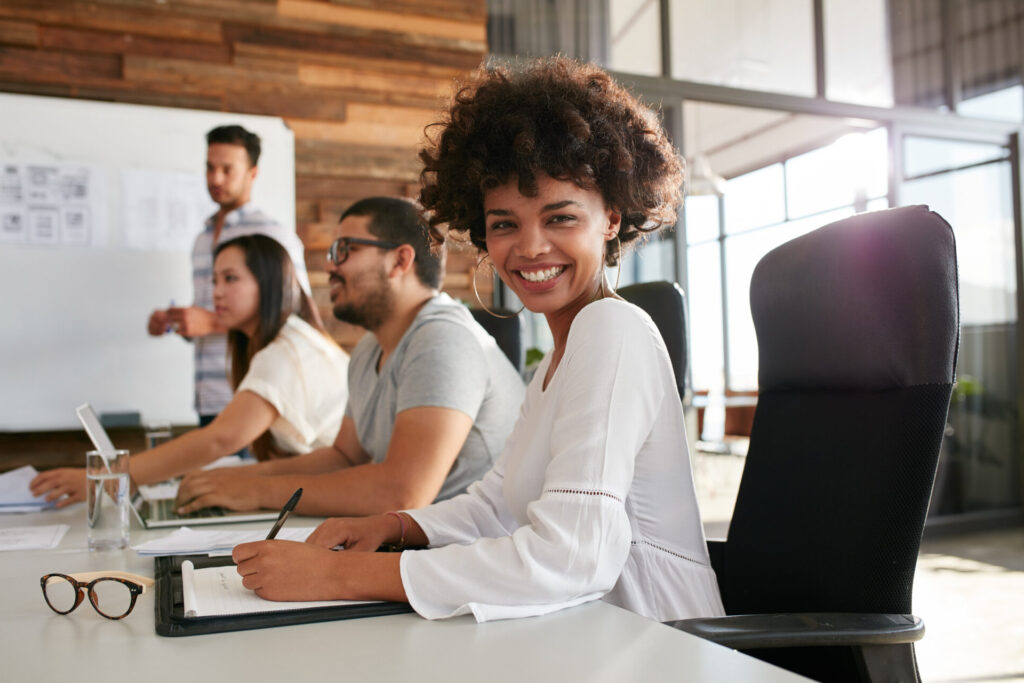 Young black woman sitting at a business presentation about innovation